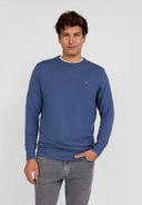 Men's blue fine knit jumper with ribbed trims and chest embroidery, front view.