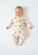 Front view of a long sleeve baby sleepsuit with floral pattern and foot coverage.