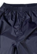 Close-up of navy waterproof overpants with elastic waistband and smooth finish.