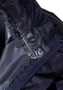 Detail of navy waterproof jacket showing inner seam and velcro.