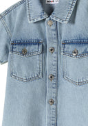 Close-up of a light blue girls' denim dress featuring a classic collar and two front patch pockets.