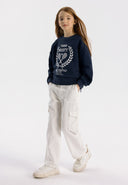 Girls navy fleece crew neck sweatshirt with decorative print, front view.