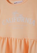 Detail of a girls' orange dress with short sleeves and tiered hem, featuring a California print.