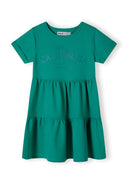 Girls short sleeve green tiered dress with decorative front print.