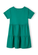 Girls short sleeve green tiered dress, back view with flared hem.