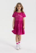 Girls pink tiered dress with short sleeves and decorative print, front view.