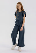 Girls' blue blouse with frill sleeves and wide-leg trousers, front view.