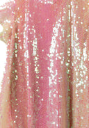 Detail of a pink girls dress with flutter sleeves and iridescent sequins.