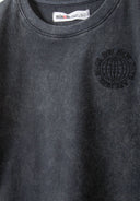 Detail of a grey short sleeve t-shirt with a round neckline and printed logo.