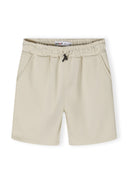 Detail of boys shorts with elastic waistband and drawstrings, featuring side pockets.