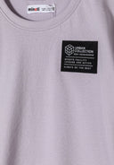 Close-up of lilac short sleeve t-shirt featuring a chest patch.