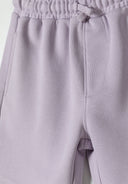 Detail of lilac shorts with elastic waistband and side pockets.