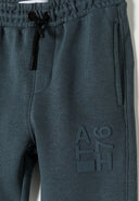 Detail of boys joggers with elasticated waistband and logo print.