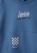 Detail of blue boys fleece hoodie with hood, kangaroo pocket, and printed logo.