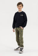 Boys khaki joggers with panel stitching, elastic waistband, and side pockets.