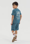 Boys green short sleeve t-shirt and shorts set, back view, featuring tennis print and elasticated waistband.