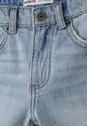 Detail of boys' ripped denim shorts in light blue with front pockets and button closure.