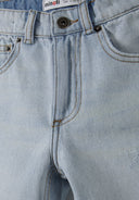 Close-up of light blue denim shorts with ripped design and front pockets.