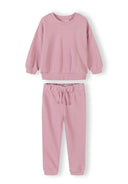 Soft pink girls tracksuit set with subtle heart design, featuring a comfortable sweatshirt and matching jogger pants.
