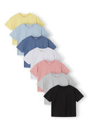 Set of seven girls’ cotton t-shirts in various pastel and neutral colors with crew neck and short sleeves, designed for comfort.