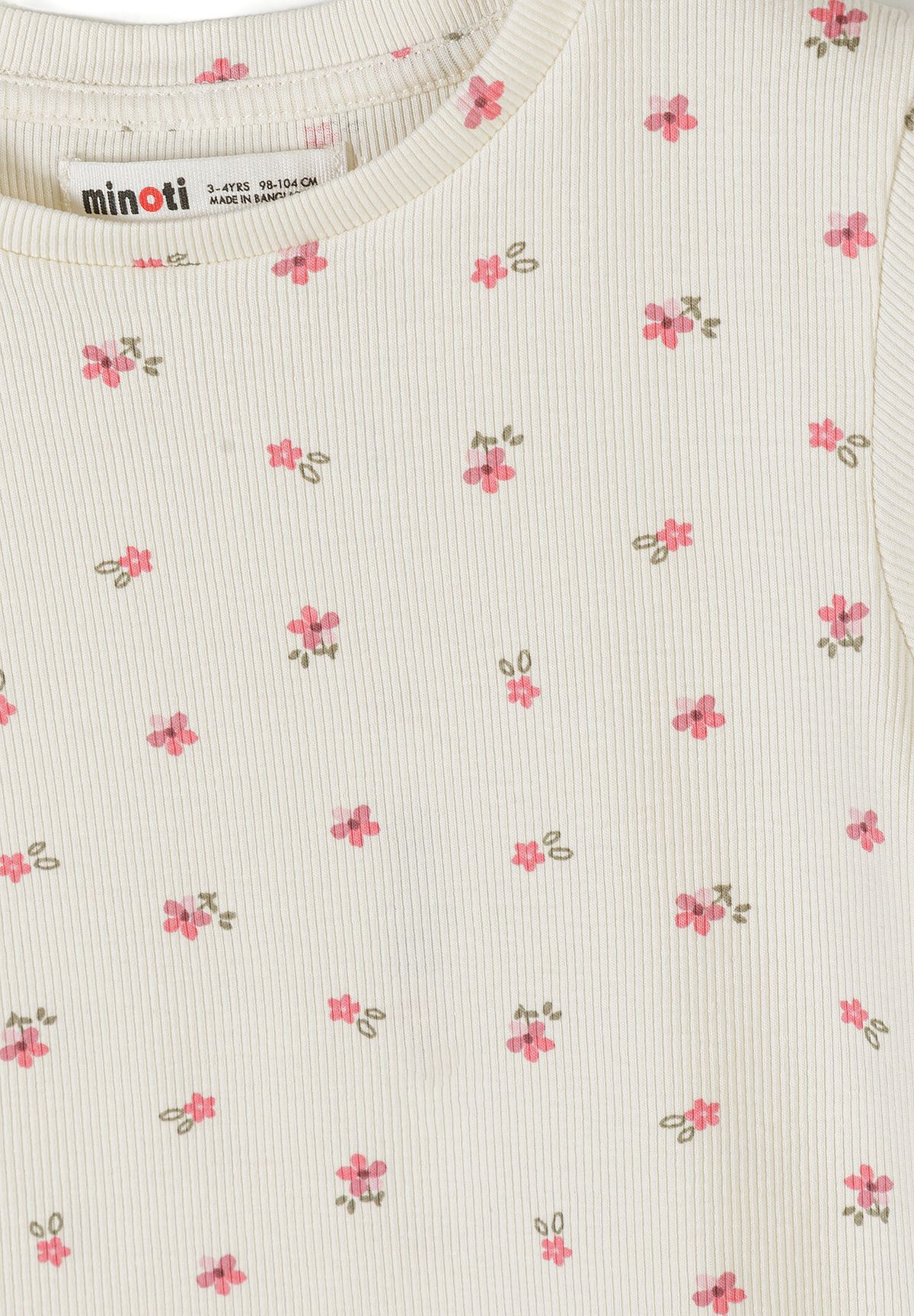 Detail view of pink ribbed fabric texture showing delicate floral print pattern and elastic waistband