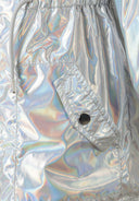 Close-up of silver iridescent fabric with flap pocket and drawstring waist detail on girls' shiny hooded jacket design