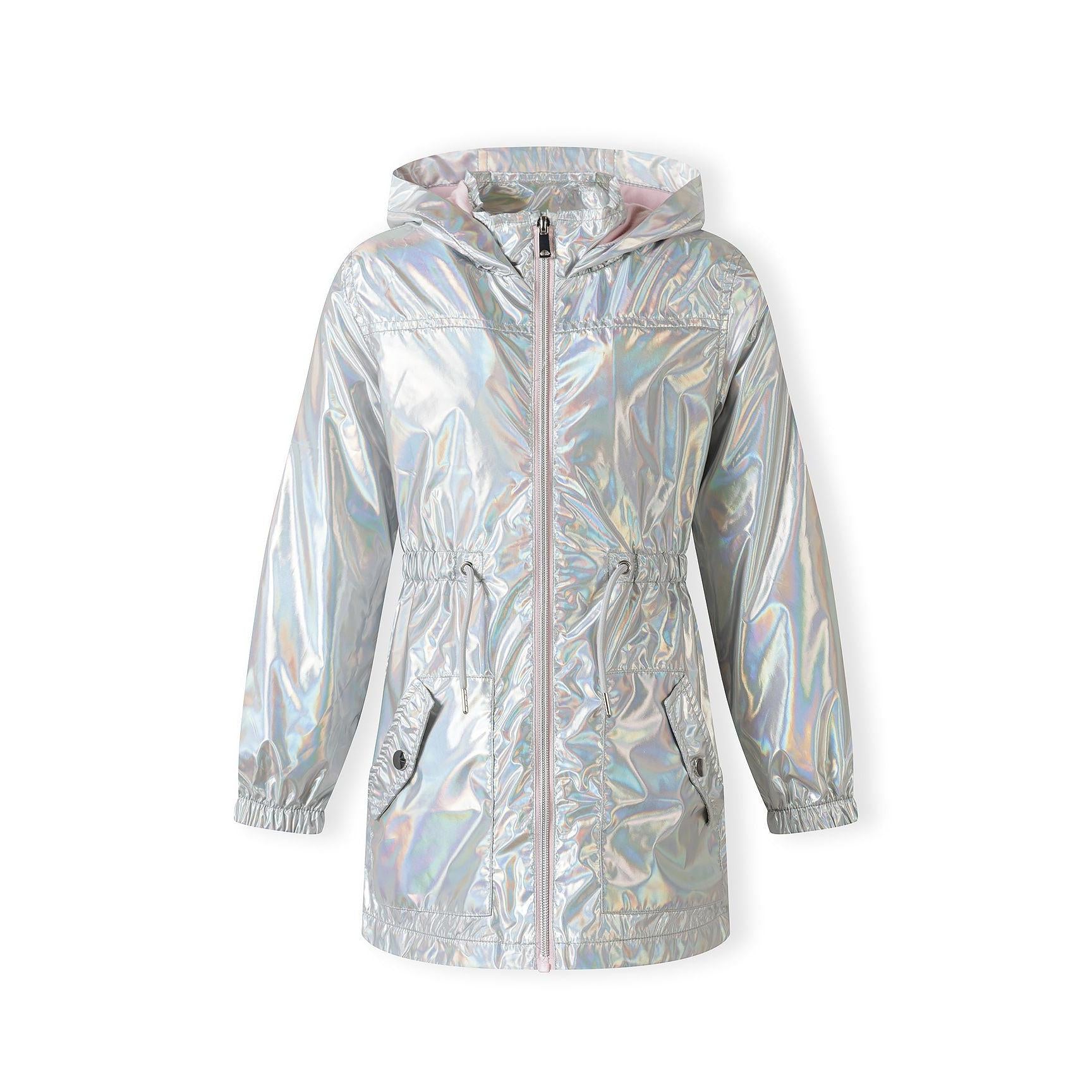 Side profile view of girl in silver iridescent rain jacket showing the relaxed fit and length, paired with dark blue jeans on light background