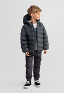 Boy wearing a lightweight padded hooded jacket with elasticated cuffs, styled with casual cargo pants and sneakers.