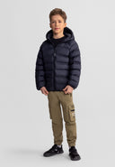 Young boy wearing a lightweight black hooded jacket with dual pockets, paired with casual khaki pants and sneakers.