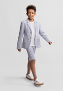 young boy in tailored cotton blazer with striped design and matching shorts walking confidently in kids fashion