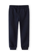 Navy blue joggers for boys with elastic waistband and cuffed ankles, designed for comfortable kids fashion.