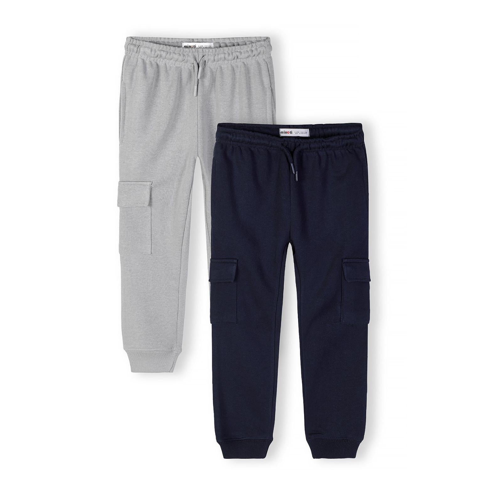 Two cargo joggers laid flat - grey on left, navy on right, showing multiple side pockets and ribbed cuffs on white background