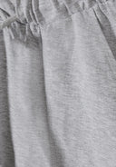 Close-up of soft grey cotton fabric with a subtle slub jersey texture and elastic waistband design for kids shorts.