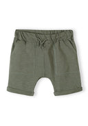 Green cotton jersey shorts for boys with elastic waistband and drawstring, featuring front pockets and rolled cuffs.