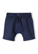 Navy blue cotton jersey shorts for boys with elastic waistband and rolled cuffs, designed for comfort and style.
