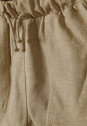 Close-up of camel-colored cotton slub jersey shorts with elastic waistband and drawstring detailing for kids.