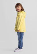 Young girl wearing bright yellow waterproof jacket with adjustable hood showcasing stylish kids fashion design.