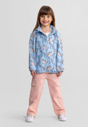 Front view of a girls' light blue softshell jacket with unicorn print and full-length zip.