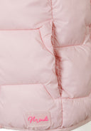 Detail of a girls pink nylon gilet with a logo badge and quilted design.
