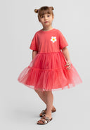 Girls jersey dress with multilayer tulle skirt, elasticated waist, and flower detail, front view.