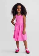 Girls sleeveless pink tiered summer dress, front view, adjustable fit.