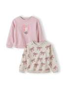 Two girls sweatshirts with a cute bunny and bow print design in soft pink and beige tones for kids.