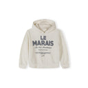 Off-white girls' hooded top with "LE MARAIS" graphic print, made from a cotton and polyester mix.