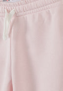Close-up of light pink girls joggers with elastic waistband and drawstring showcasing soft fabric and simple design.