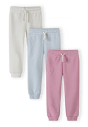 Set of three pastel joggers in light blue, white, and pink with drawstring waist, designed for kids.
