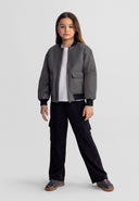 Young girl wearing black wide leg joggers with combat pockets and an elasticated waist standing confidently