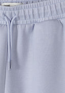 Close-up of soft blue elastic waistband with drawstring on kids shorts featuring simple, comfortable design for babies.