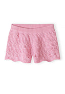 Pink crochet knit shorts with scalloped hem and intricate lace-style pattern for girls’ summer fashion.