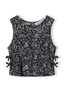 Black sleeveless girls pullover with white floral print and side bow details featuring a unique design.