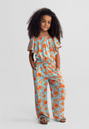 Young girl wearing a light blue floral viscose set with a stylish off-shoulder top and relaxed pants design